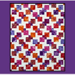 May include: A colorful quilt with a repeating pattern of squares in shades of red, orange, purple, and pink against a white background. The quilt features the text "La Rue" in a script font. The quilt is framed in a purple border.