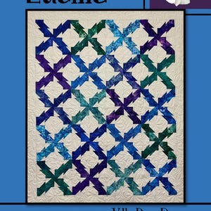 May include: A quilt with a geometric pattern in shades of blue, teal, and purple, set against a cream background. The quilt features the name "Lucille" and the text "Villa Rosa Designs". A pink rose is in the upper right corner.