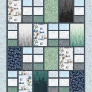 May include: A quilt pattern called "Divisions: A Pieced Quilt" with a patchwork design featuring various shades of blue, green, and white. The quilt is made up of squares and rectangles, and the pattern is repeated throughout the quilt. The quilt is surrounded by a light blue border.