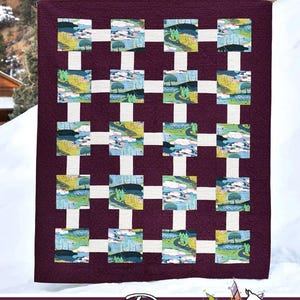 May include: A quilted textile with a grid pattern. The quilt features a deep purple background with a white grid overlay. Within the grid are landscape scenes in shades of green, blue, and yellow. The text "Gridwork" and "Running Doe Quilts" are visible.