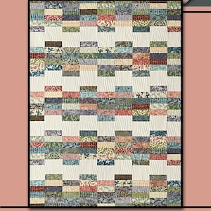 May include: A patchwork quilt with a cream backdrop and rectangular blocks in shades of blue, green, and red. The quilt features the text "THE LADY" and "Villa Rosa Designs". A pink rose is in the upper right corner.