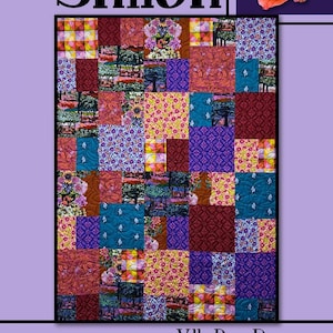 May include: A quilt pattern called "Shiloh" by Villa Rosa Designs. The quilt is made up of colorful squares with floral, geometric, and plaid patterns. The quilt is surrounded by a purple border with a floral design.
