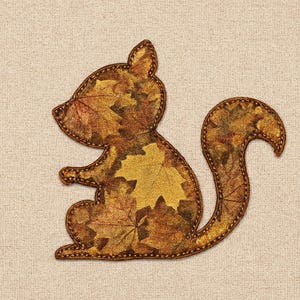 May include: A squirrel-shaped applique with a fall leaves design. The squirrel is filled with a pattern of brown, gold, and orange leaves. The edges are outlined with a brown stitched border. The applique is on a beige background.