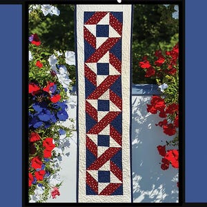 May include: A patriotic quilt pattern titled "Stars & Ribbons" with a red, white, and blue color scheme. The design features star and ribbon motifs. The image includes text with the designer's name and design company.