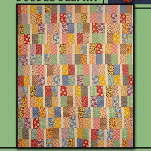 May include: A colorful quilt with a patchwork design featuring various floral and geometric patterns in red, yellow, blue, and green. The quilt has the text "DOUBLE DELIGHT" and "Villa Rosa Designs". A red rose is in the upper right corner.