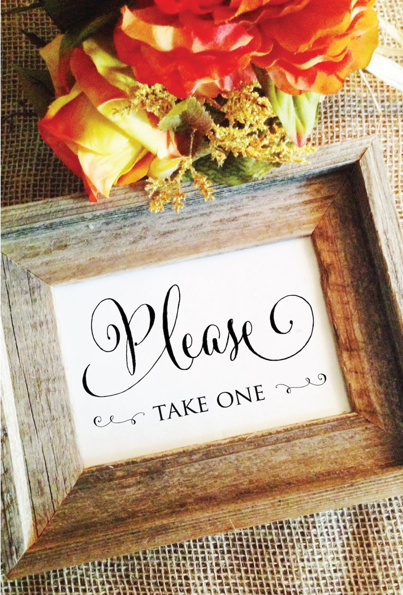 May include: A rustic wooden framed sign with the word "Please" in elegant script, followed by "TAKE ONE" in a smaller font. The sign is decorated with floral arrangements in shades of orange and yellow.