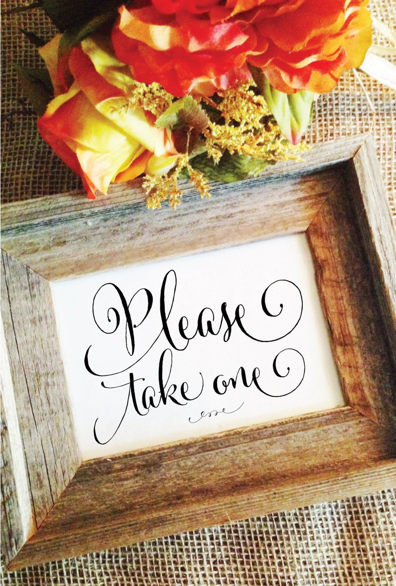 May include: A framed sign with the words "Please Take one" in elegant black script. The frame is made of rustic, weathered wood. Orange and yellow flowers are at the top of the frame.