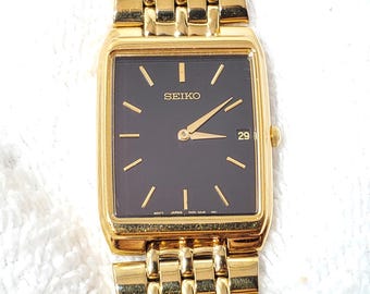 Reloj de cuarzo vintage Seiko para hombre, modelo Date Tank, chapado en oro, esfera negra, una joya.