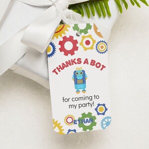 May include: A white thank you tag with a blue robot illustration and the text "Thanks a bot for coming to my party!" with the name Ethan at the bottom. The tag is decorated with colorful gears.