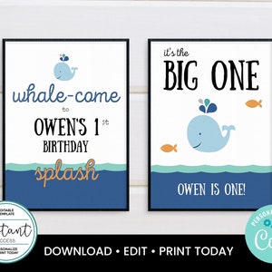 May include: Two framed birthday signs with a whale theme. One sign says "whale-come to Owen's 1st birthday splash". The other says "it's the BIG ONE" with a whale and fish. The signs are blue, white, and orange.