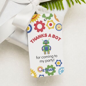 May include: A white thank you tag with a robot and gears. The text on the tag reads "Thanks a Bot for coming to my party! Ethan".