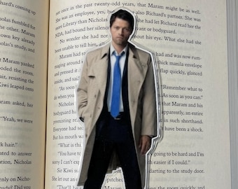 May include: A man wearing a beige trench coat with a blue tie and a white shirt. He is standing in front of a book with text about a bodyguard. The text reads "As soon as you can."
