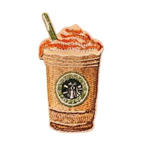 May include: Embroidered patch of a coffee drink with whipped cream and a straw. The cup has the Starbucks logo on it.
