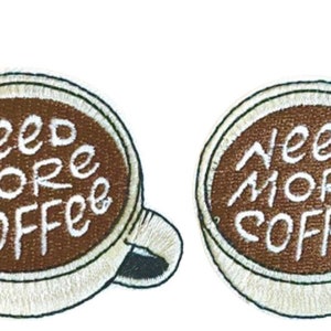May include: Two brown and white embroidered iron-on patches with a coffee cup design. The text on the patches reads "Need More Coffee".