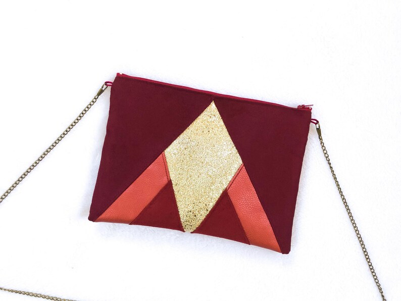 burgundy and gold clutch bag