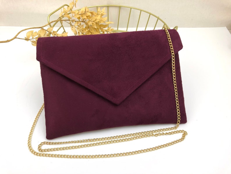 Plum burgundy envelope clutch ideal for storing the essentials for an evening image 1