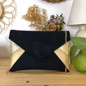 Black and gold clutch ideal for an evening or everyday use with a choice of bag chain or wrist strap.