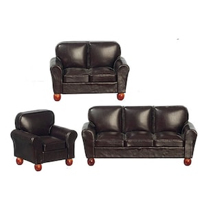 May include: A set of three brown leather couches, including a loveseat, a three-seater sofa, and an armchair. The couches have a tufted design and wooden legs.