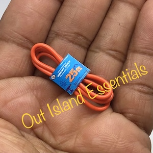 May include: Orange heavy-duty extension cord, coiled and secured with a blue label. The label reads "HEAVY DUTY" and "25m". The cord is a vibrant orange color, and the label has a graphic of a person.