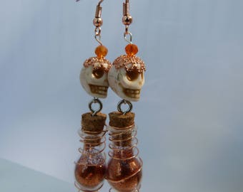 Dangling sugar skulls with their own magic pixie dust,copper day of the dead earrings