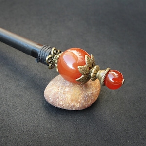 Wooden based hairpin with two agate gemstones in brown color. The stick length is adjusted to customers' specifications.