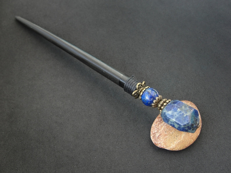 May include: Black wooden hair stick with a lapis lazuli gemstone and brass accents.