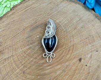 Tourmaline wire wrapped in silver plated German style wire
