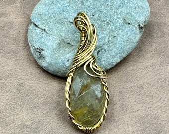 Quartz pendant wrapped in gold brass wire