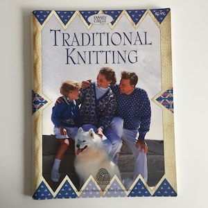 May include: A vintage book titled "Traditional Knitting" with a family portrait on the cover. The image shows a family of three and a white dog. The book has a blue and gold border with the text "Family Circle" at the top.