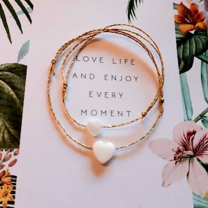 2 small love heart bracelets, lucky charms, sharing...mother/child...friends...mother-of-pearl on gold linen cord, adjustable in all sizes...pair of 2