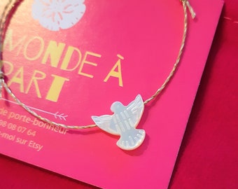 Lucky dove bracelet..symbol of peace, love, hope..precious, fine, delicate..mother-of-pearl bird engraved on gold waxed linen cord.