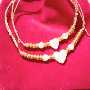 2 Lucky charm bracelets...little heart of love, of sharing...mother/daughter...grandma...girlfriends...mother-of-pearl on gold linen cord, adjustable in all sizes...pair of 2