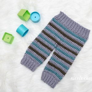 May include: Striped baby pants in shades of gray, teal, and brown. The pants are crocheted and have a relaxed fit.