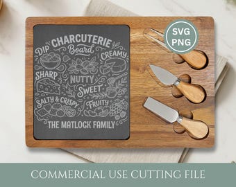 May include: Wooden charcuterie board with a dark gray slate insert engraved with "Dip Charcuterie Board" and food illustrations. Includes three cheese knives and the text "The Matlock Family".