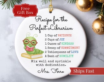May include: White ceramic ornament with a gold hanging loop. The ornament features the text "Recipe for the Perfect Librarian" and a cartoon caterpillar reading a book. The recipe includes "1 Ounce of KINDNESS".
