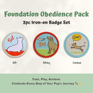 May include: A set of three iron-on badges for dog training. Each round badge features a different command: "Sit," "Stay," and "Come." The badges have colorful designs with text and illustrations of dogs. The text "Foundation Obedience Pack" is at the top.