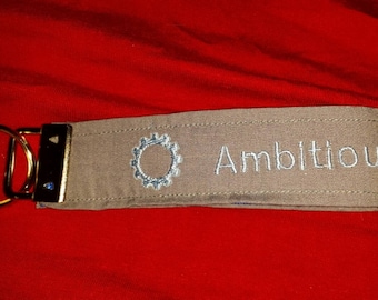 The Grand Tour inspired "Ambitious but rubbish" wristlet keychain