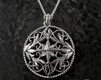 May include: A silver pendant necklace with a floral design. The pendant is circular, featuring intricate leaf and vine patterns within a beaded border. The necklace has a delicate chain and is displayed against a dark background. The text "LittleTreasuresByMir.etsy.com" is visible.