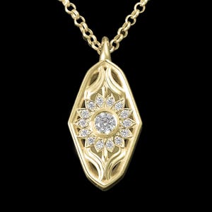 May include: A gold pendant necklace featuring a diamond-encrusted sunburst design. The pendant is shaped like a hexagon with rounded edges and has intricate floral details.