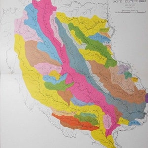 May include: A vintage map of North Eastern Iowa, featuring a colorful illustration of the region's drainage basins. The map uses a variety of colors, including pink, yellow, and blue, to differentiate the areas. The title "Drainage Basins of North Eastern Iowa" is visible.