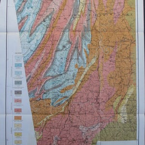 May include: A vintage geological map of the Appalachian Valley and Cumberland Plateau of Georgia, dated 1912. The map features a detailed color-coded representation of the region's geological formations, with a legend on the left side. The map is folded.