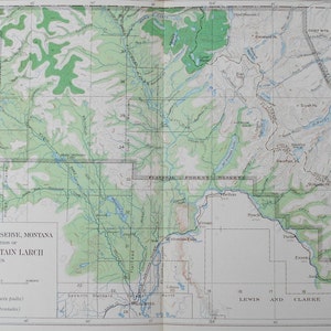 May include: A detailed map of the Flathead Forest Reserve in Montana, showing the distribution of Larch and Mountain Larch. The map features green and brown shaded areas, with text labels and a scale. The map is folded.