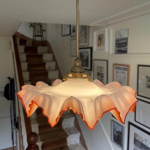 French vintage white opaque glass hanging light with orange/pink frilly edge, c1930s.