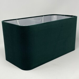 May include: A dark green rectangular lampshade made of fabric.
