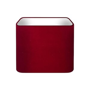 May include: A square-shaped lampshade featuring a deep burgundy red exterior with a smooth, solid finish. The top edge of the lampshade is finished with a reflective, metallic silver trim that creates a sharp contrast against the dark red fabric.