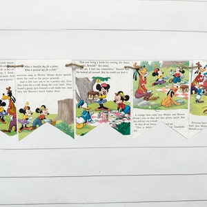May include: A vintage paper banner featuring Mickey Mouse and his friends enjoying a picnic. The banner is decorated with colorful illustrations and text from a children's book. The text reads, "What a beautiful day for a picnic, what a picnic day for a little..."