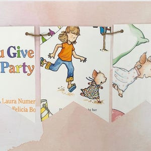 May include: A banner featuring illustrations from the children's book "If You Give a Pig a Party." The artwork depicts a girl and a pig in various scenes, with the title and author's names visible. The banner is strung with twine.