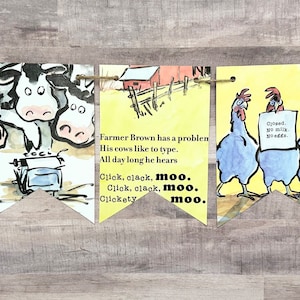 May include: A yellow and white banner with a farm theme. The banner has five sections with illustrations of cows, chickens, and a typewriter. The text on the banner reads "Click, clack, moo. Cows that type." and "Farmer Brown has a problem. His cows like to type. All day long he hears Click, clack, moo. Click, clack, moo. Clickety moo."