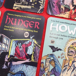 May include: A collection of vintage-style comic book cards with horror themes. The cards feature colorful illustrations and text, including the words "Hunger" and "Howl." Each card has a 10-cent price tag.
