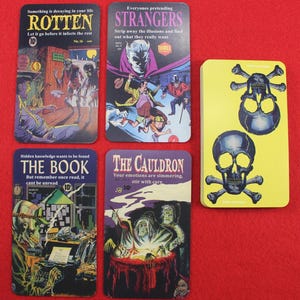 May include: A collection of vintage-style coasters with horror comic book art. The coasters feature images of zombies, a cauldron, and skulls. Each coaster has a unique title and text, with a yellow coaster featuring two skulls and crossbones.